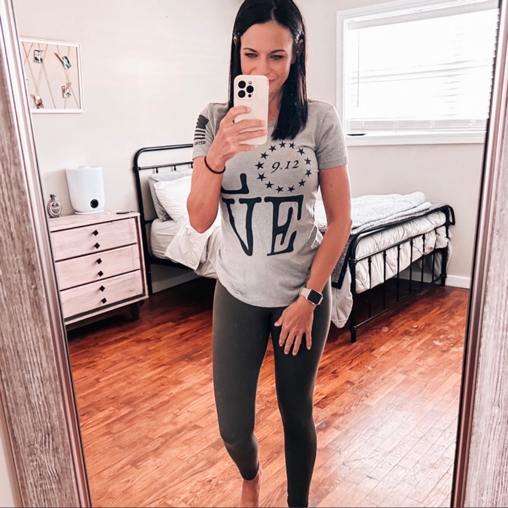 9/12 United tee in gray with “LOVE” graphic on front and flag on sleeve